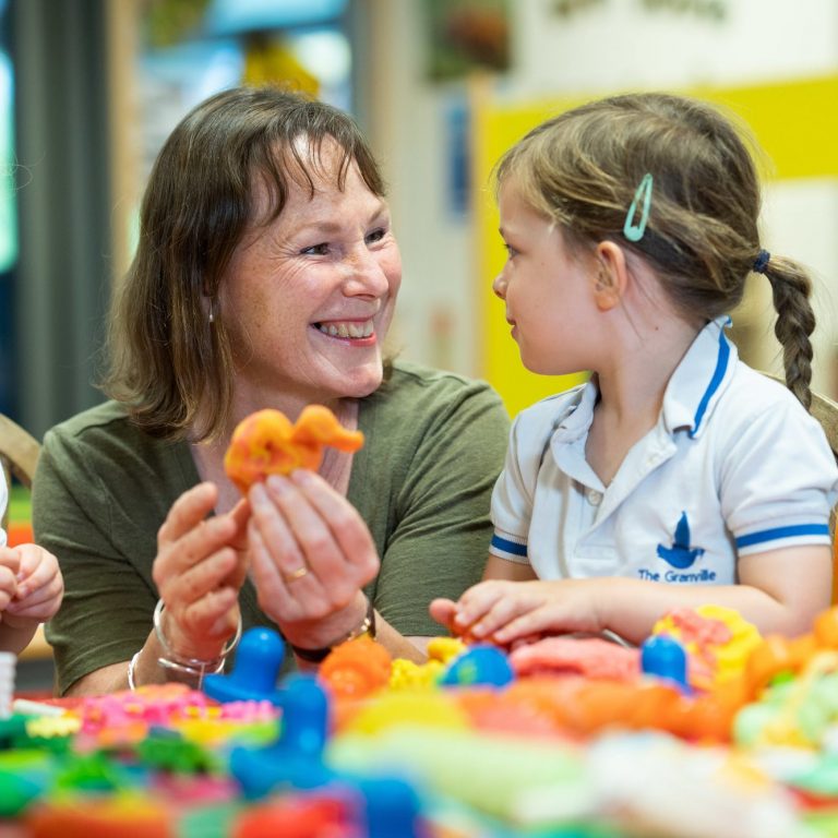 teacher helping a girl