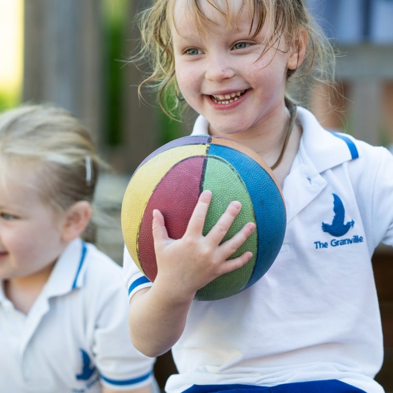 girl holding a ball