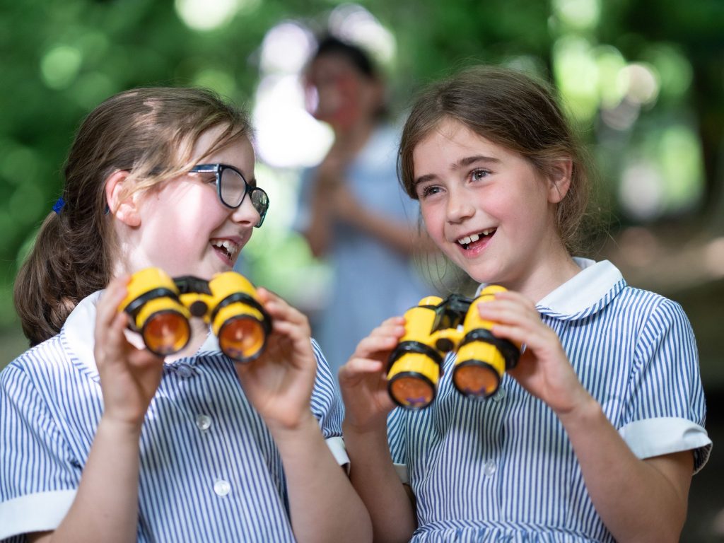 girls using binoculars