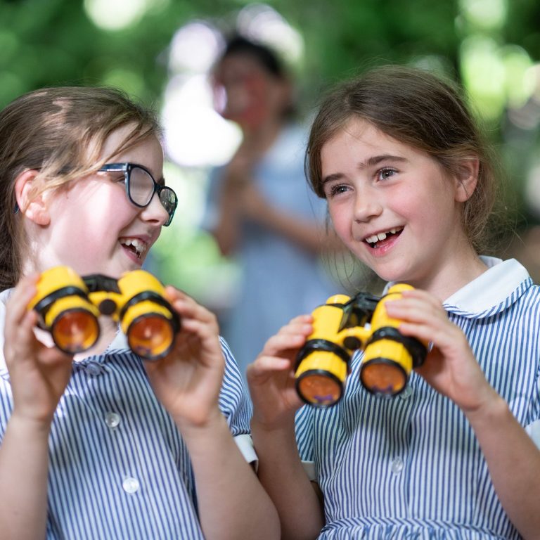 girls using binoculars