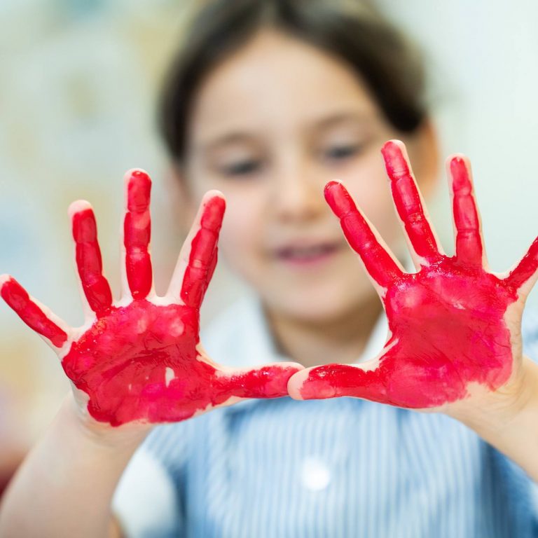 girl with red paint on her hands