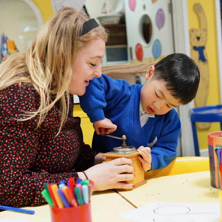 teacher helping pupil