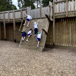 children climbing a wooden draw bridge