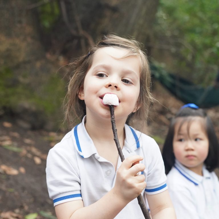 girl eating a roasted marshmallow