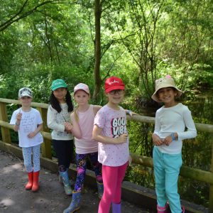 children stood against a wooden fence