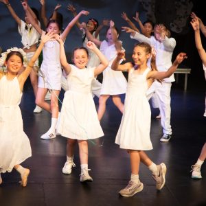 children performing on stage