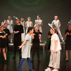 children performing on stage