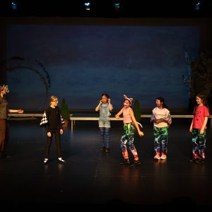 children performing on stage