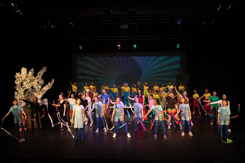 children performing on stage