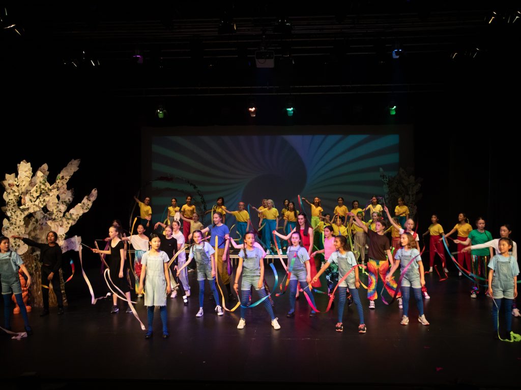 children performing on stage